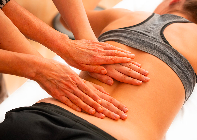 lady receiving physiotherapy treatment on her back